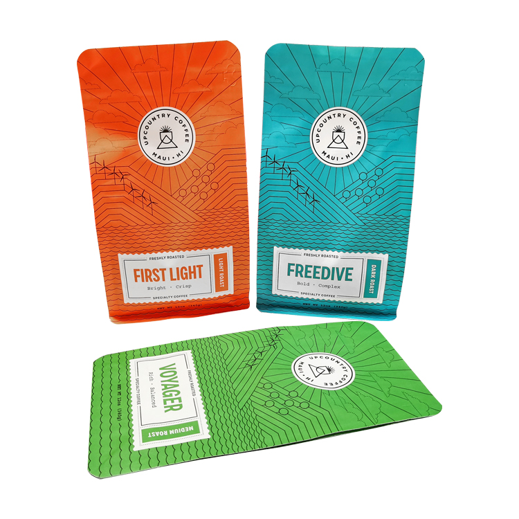 Orange, blue and green coffee bags with landscape line artwork and white labels