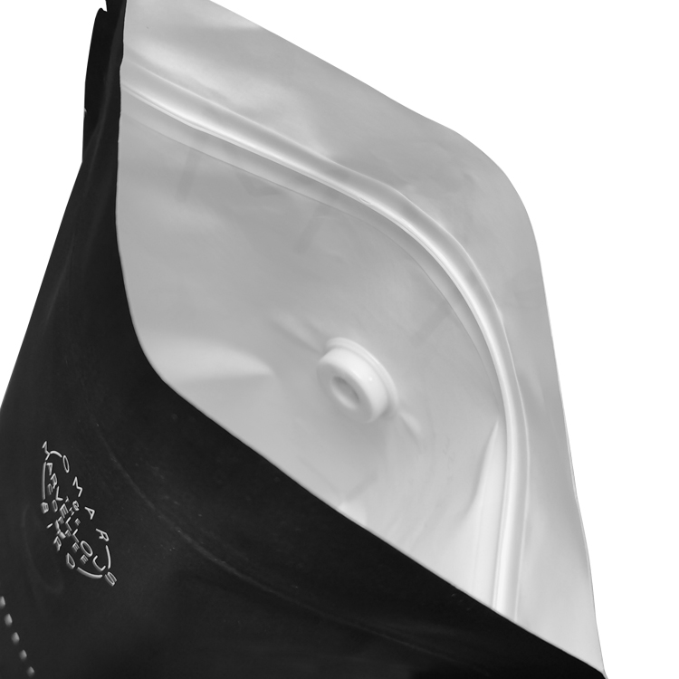 Open dark coffee pouch showing its pale interior valve and closure