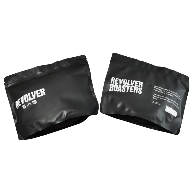 Two angled black coffee pouch views with white graphics
