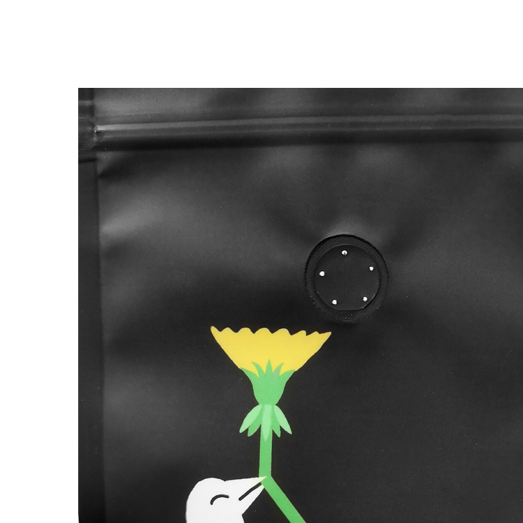 Close view of the valve above a yellow flower on a black pouch