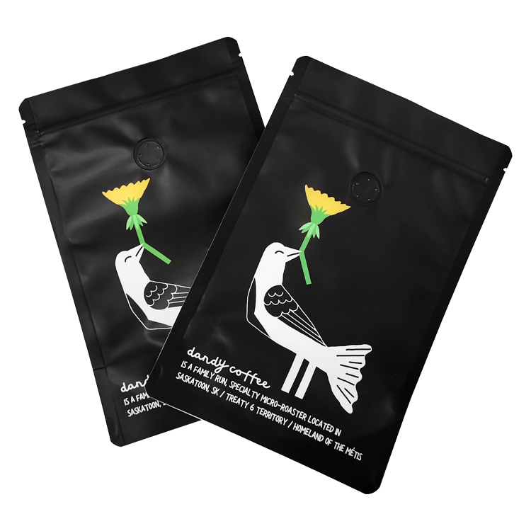 Two black pouches carrying a bird with a yellow flower