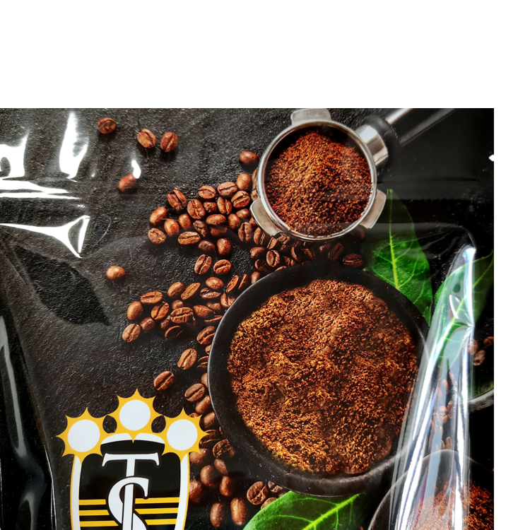 Close view of printed beans ground coffee and brand artwork