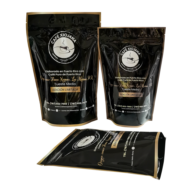 Two upright black and gold-colored pouches beside a laid-down bag