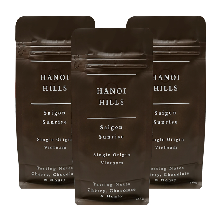 Three dark brown coffee bags with matching front artwork