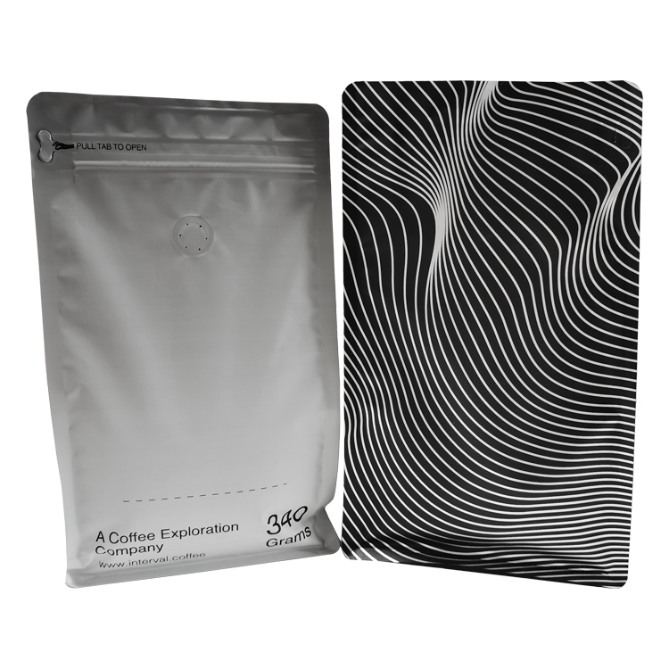 Two printed flat bottom coffee bag views showing graphic artwork, text and a pull-tab opening