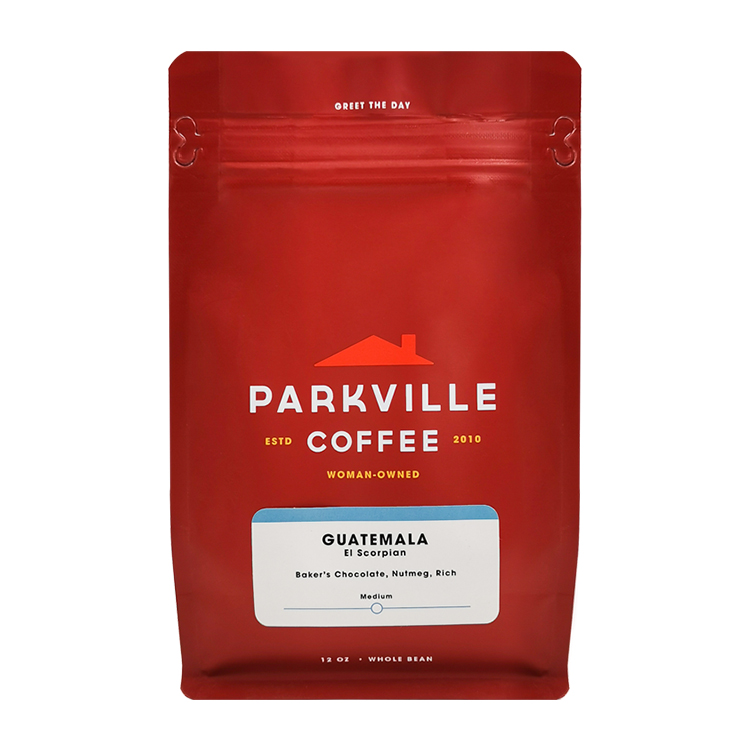 Front of a red coffee bag with white lettering and a white information label