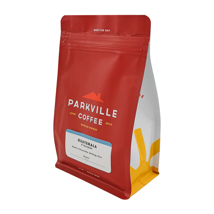 Angled red coffee bag showing a white and yellow side panel