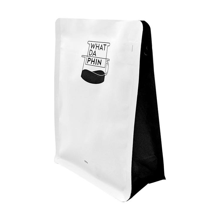 White and black flat bottom coffee bag with a white label panel