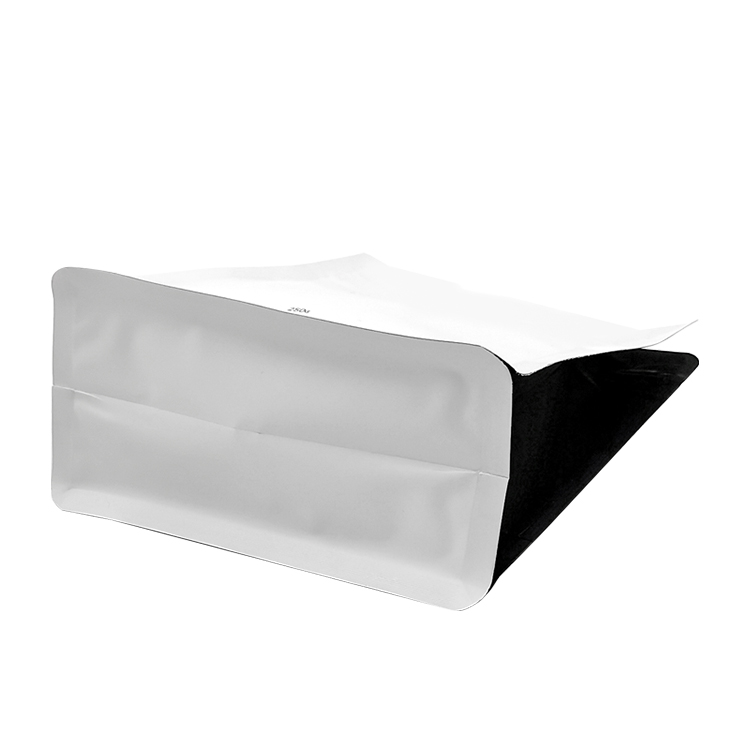 White coffee bag laid down to show the base and black side
