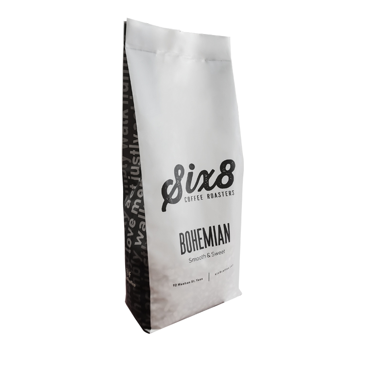 Upright white coffee bag shown at an angle with the side fold visible
