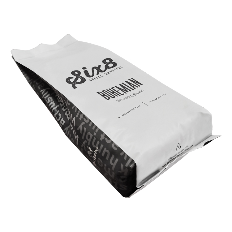 White coffee bag laid down with folded side and bottom areas visible