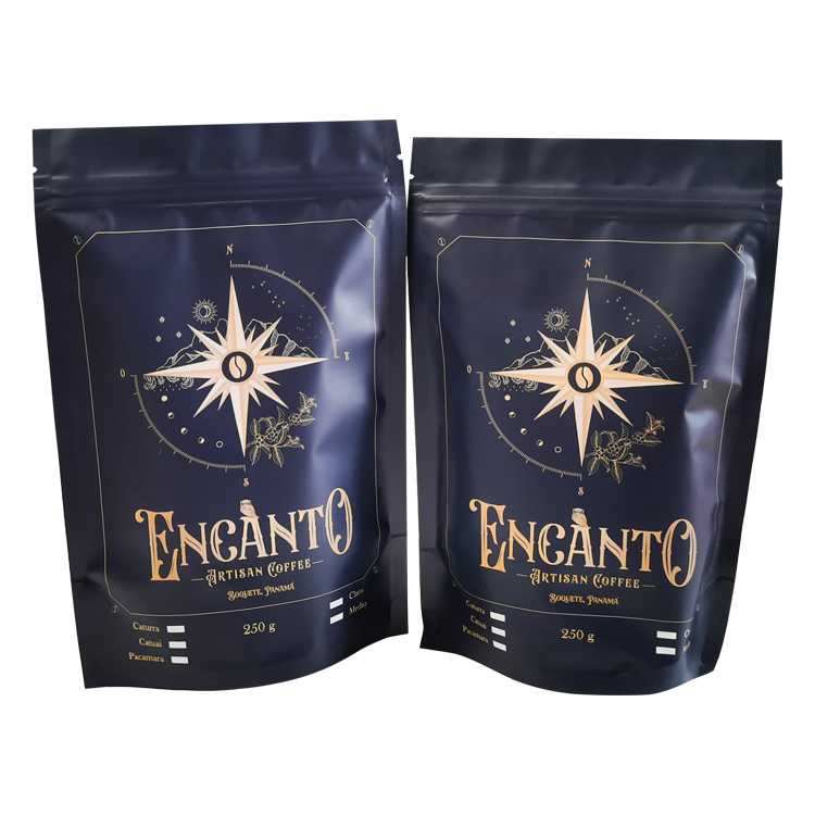 Two dark blue coffee pouches with gold-colored compass artwork and printed 250 g weight statements