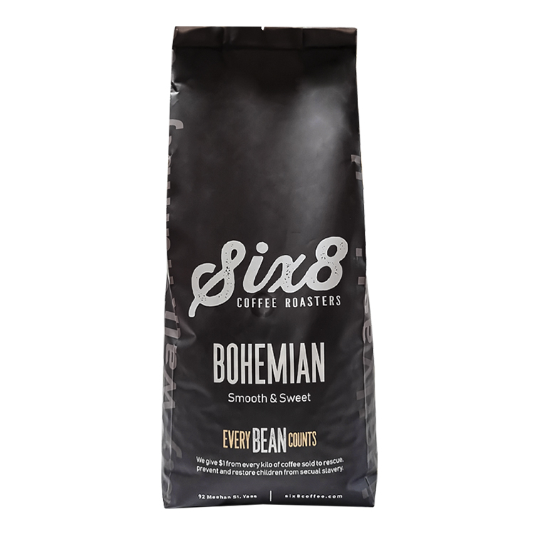 A black side gusset coffee bag with white brand lettering photographed against a white background