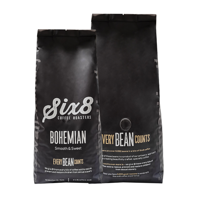 Front and back of dark coffee bags with a valve on the back