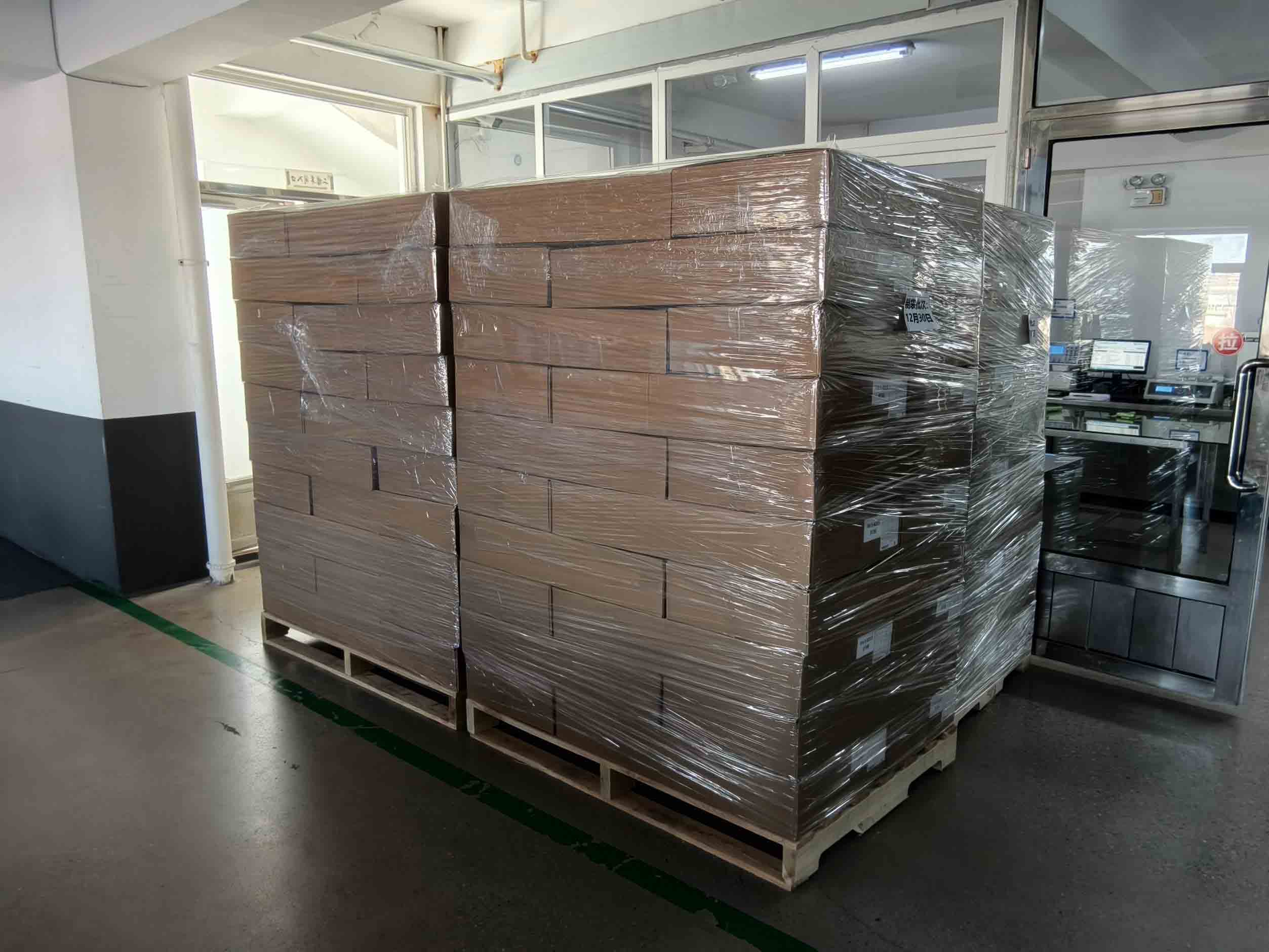 Packed cartons stacked on a pallet and secured with stretch wrap
