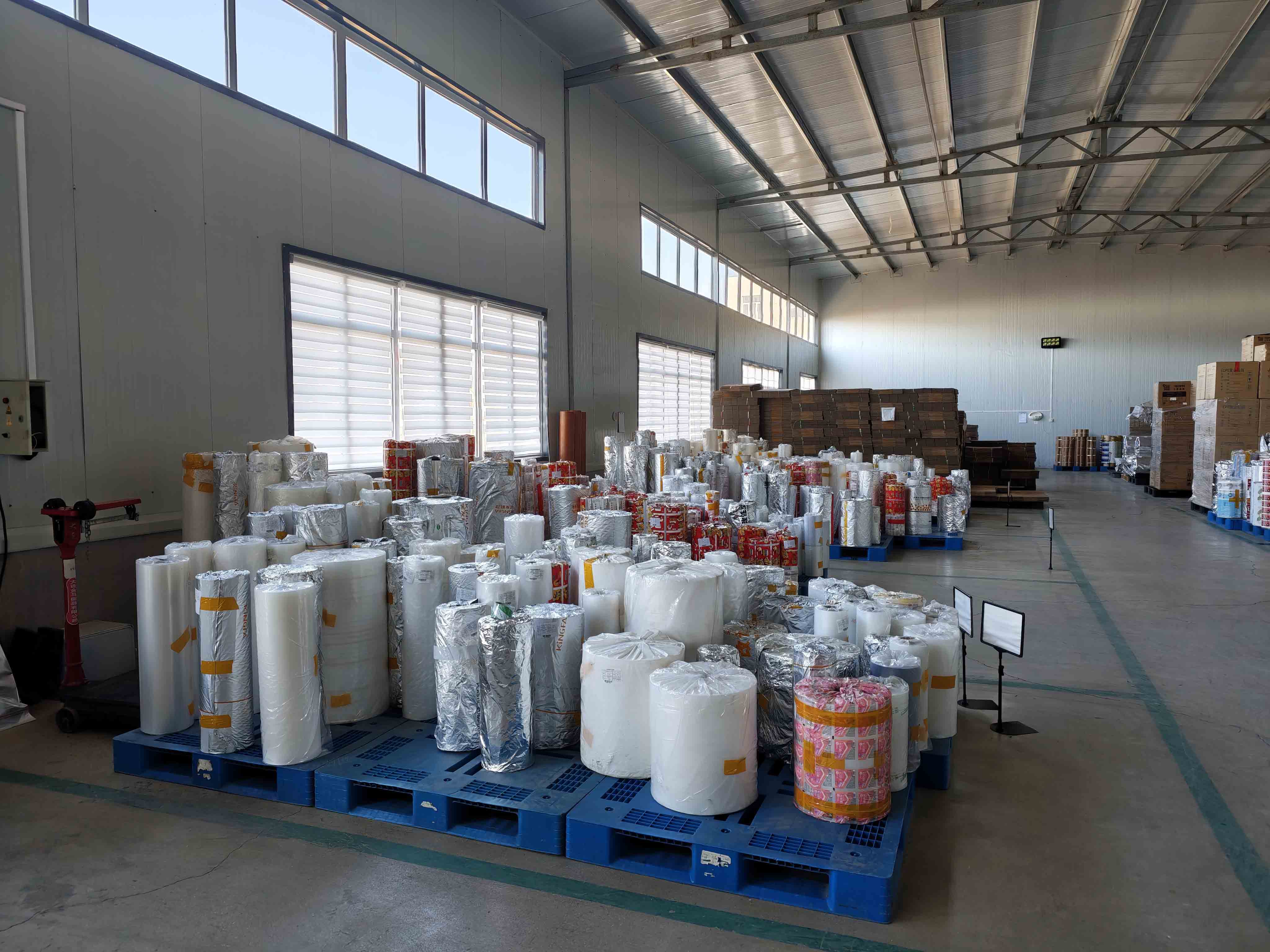Packaging film rolls on pallets inside the materials warehouse