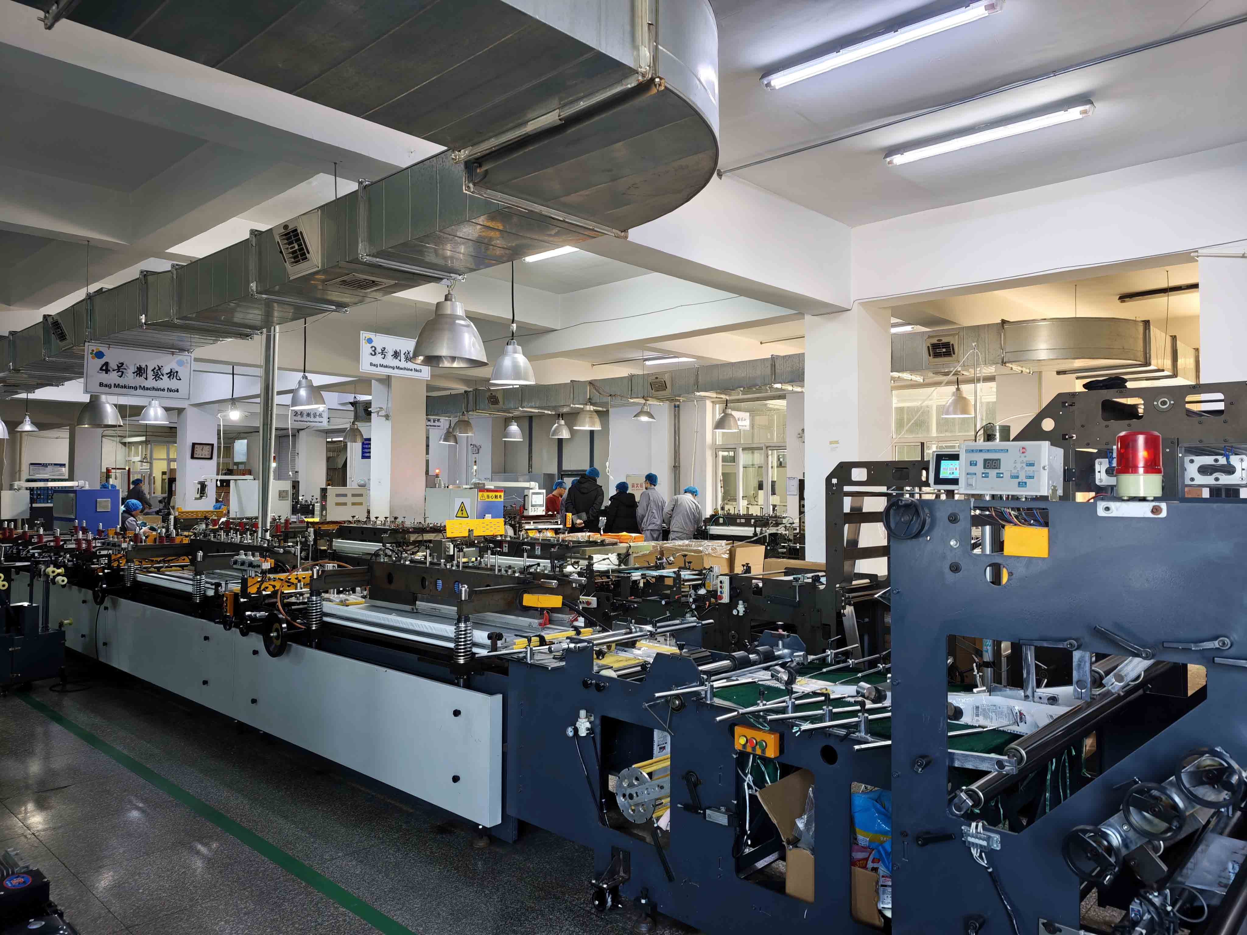 Wide view of pouch-making machinery in the workshop